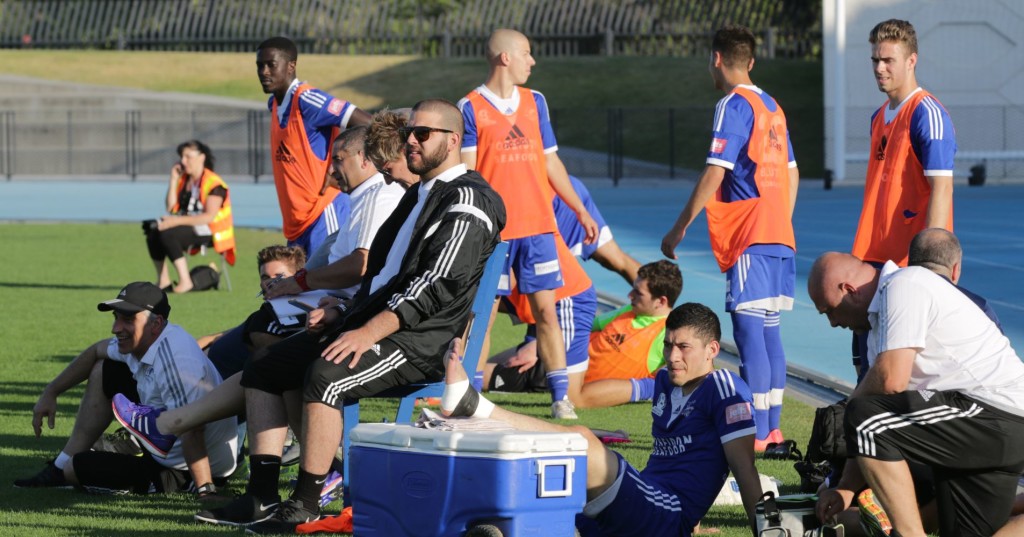 Coach Greg Kassidas and the squad watch the pre-season friendly against South Melborne FC at Lakeside Stadium